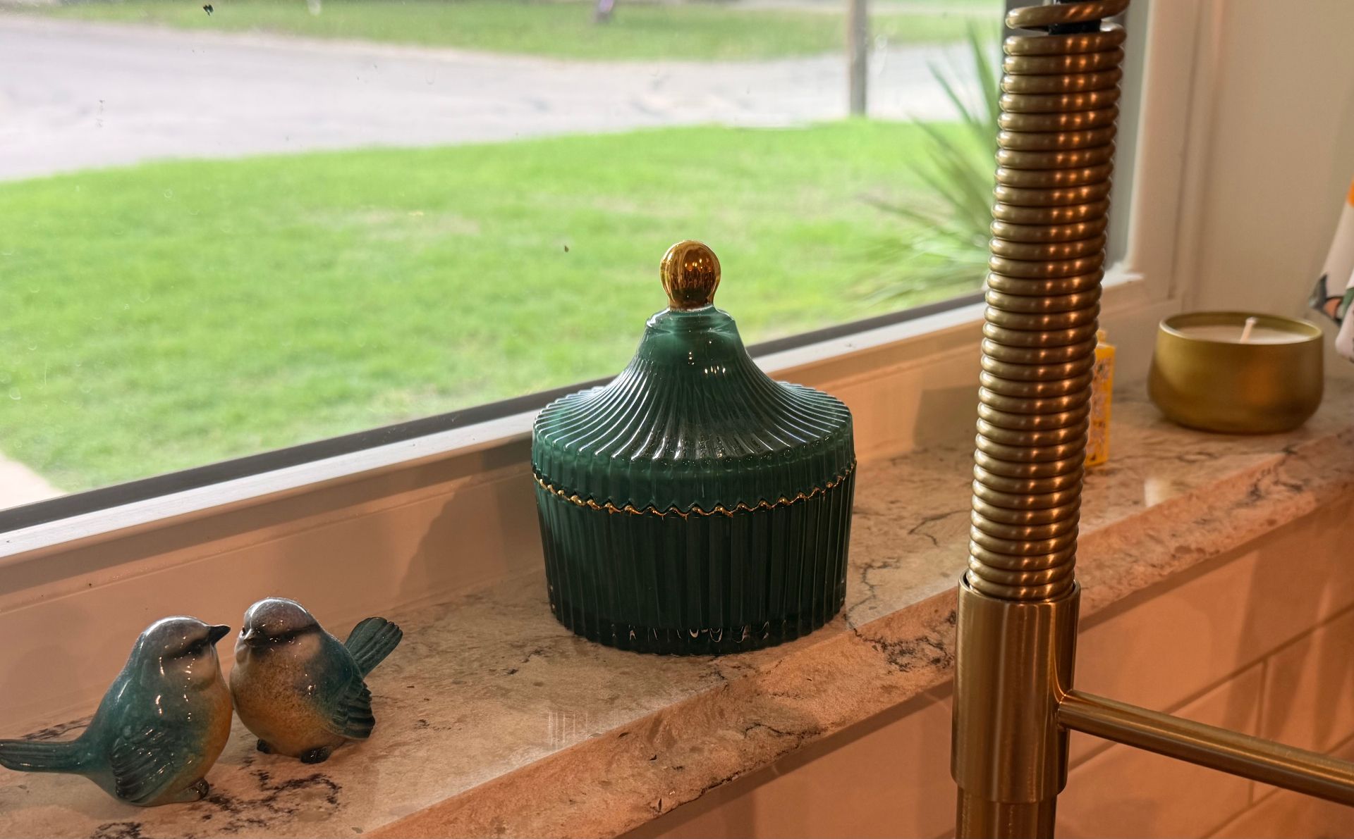 Green Seventh Sense Home refillable vessel beside a kitchen window