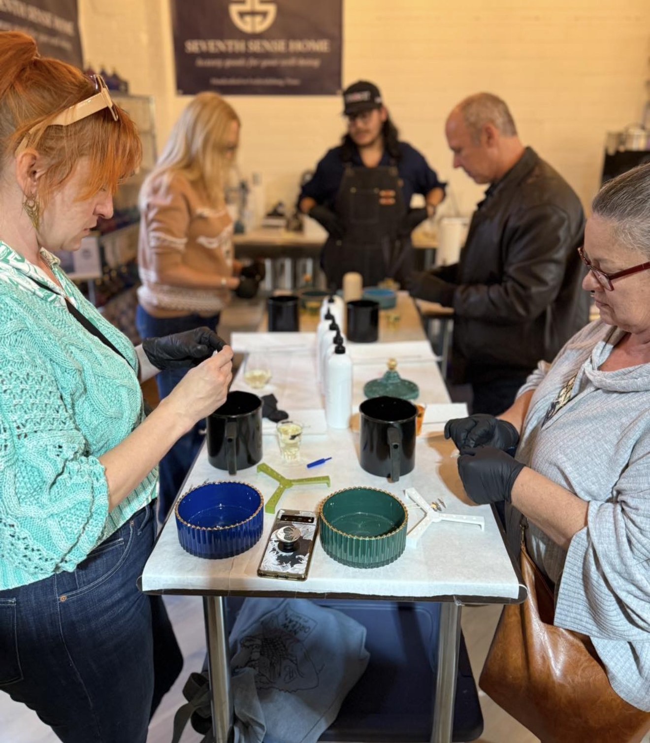 Guests pouring candles together at a Seventh Sense Studio Pour