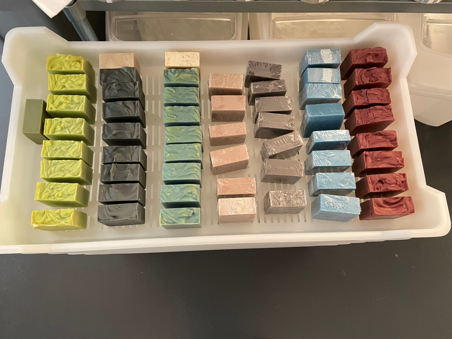 Trays of freshly cut Seventh Sense Home soap bars curing in the studio