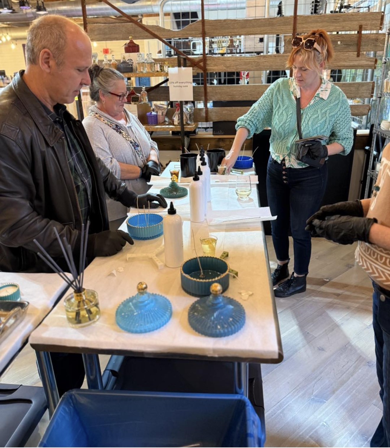 Guests preparing wicks and vessels at the Studio Pour table