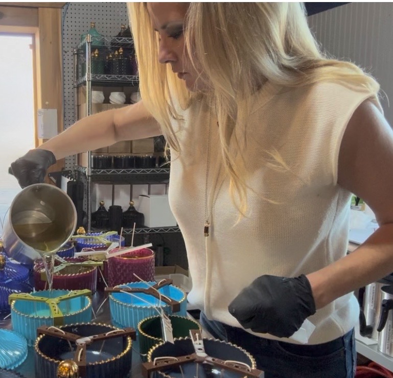 Founder hand-pouring soy candles into vessels at the Seventh Sense Home studio in Kerrville, Texas